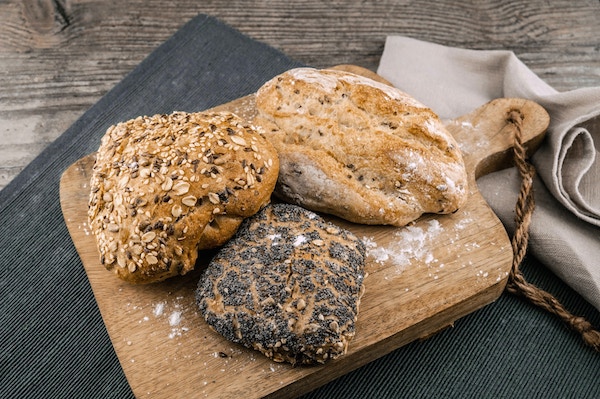 three different breads with flaxseeds and other whole grains